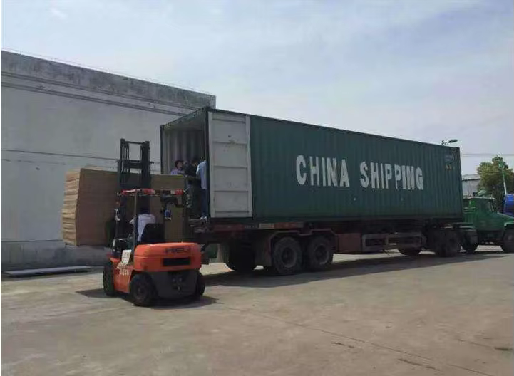 Supplied photograph of a forklift and shipping container during loading; location and ownership not asserted